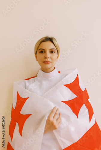  woman with fencing uniform and state flag of Georgia photo