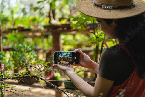 Woman taking pictures of her plants photo