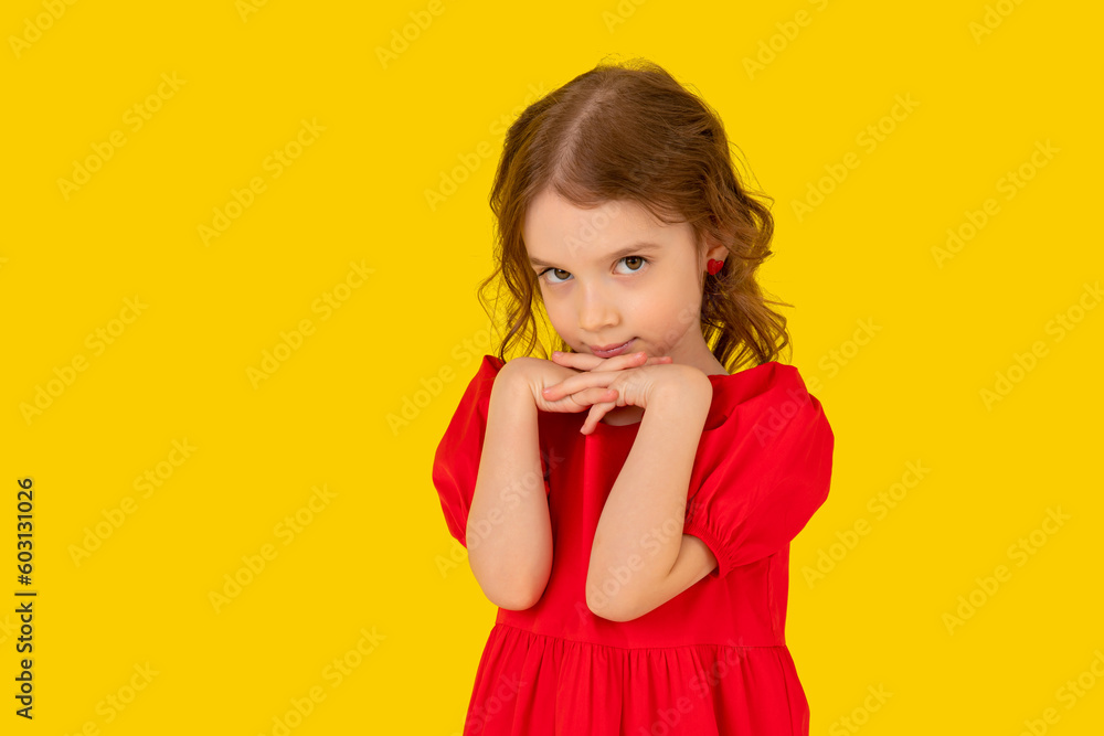 Portrait thoughtful girl in party dress isolated on yellow background with long hair, european appearance, in the position of the hand under the chin with a dreamy look dreaming child, generation Z Portrait thoughtful girl in party dress isolated on yellow background with long hair, european appearance, in the position of the hand under the chin with a dreamy look dreaming child, generation Z