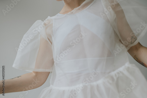 Woman with see through airy dress posing in various light  photo