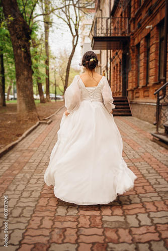 without a face. Rear view of a dark-haired woman in a wedding dress. 