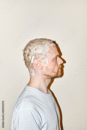 Young Man while dyeing his hair
 photo