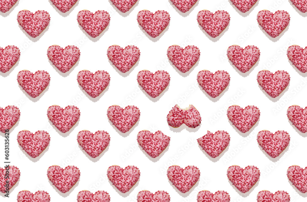 Pattern of heart shaped pink donut with glaze on white background Pattern of heart shaped pink donut with glaze on white background