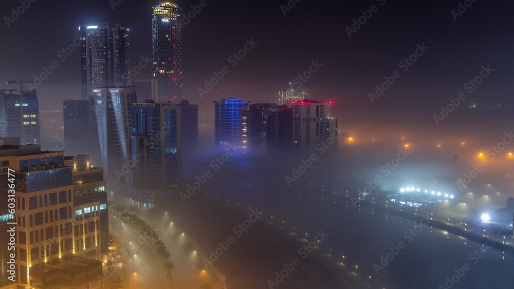 Buildings are covered in thick layer of fog in Business Bay night timelapse.