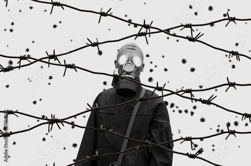 Soldier In Gas Mask Behind Barbed Wire photo