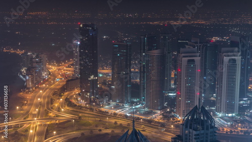 JLT and Dubai marina skyscrapers near Sheikh Zayed Road aerial all night timelapse. Residential buildings