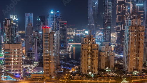 Skyscrapers of Dubai Marina near intersection on Sheikh Zayed Road with highest residential buildings all night timelapse