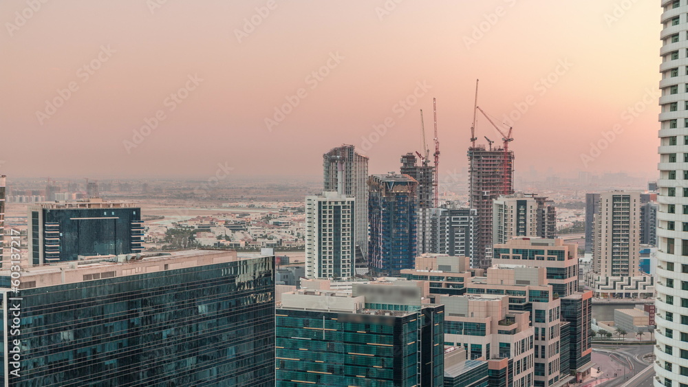Dubai's business bay office towers aerial timelapse. Rooftop view of some skyscrapers
