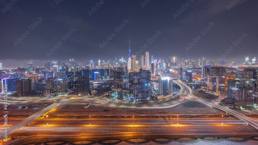 Panoramic skyline of Dubai with business bay and downtown district day to night timelapse.