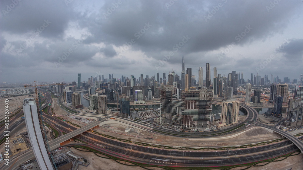 Obraz premium Panoramic skyline of Dubai with business bay and downtown district night to day timelapse.