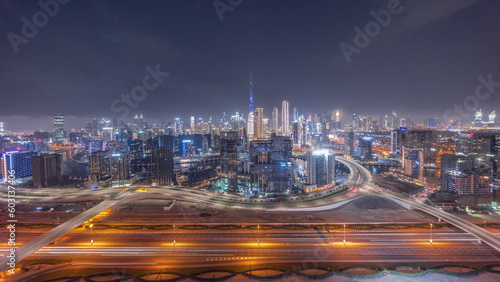 Panoramic skyline of Dubai with business bay and downtown district day to night timelapse. photo
