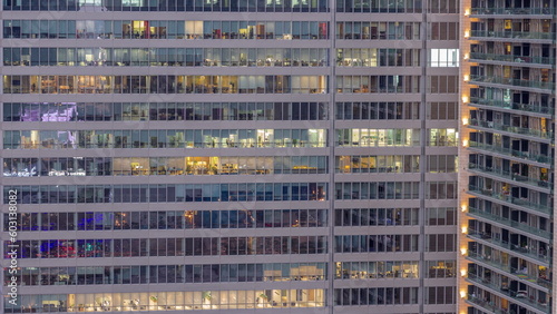 Windows of office buildings day to night timelapse, the light from the windows of houses
