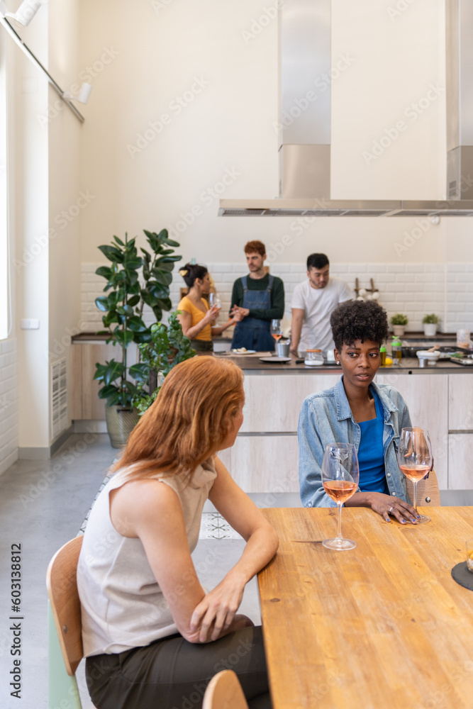 Diverse Friends Chatting And Having A Glass Of Wine In The Kitchen. Diverse Friends Chatting And Having A Glass Of Wine In The Kitchen.