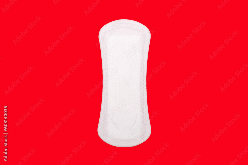 Feminine hygiene menstrual pad for the menstrual cycle on a red background. Feminine hygiene product in the form of a sanitary napkin. A clean menstrual pad
