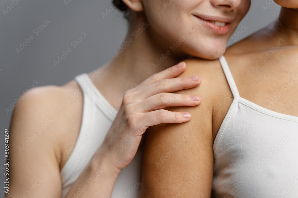The woman rested her chin on the other woman's shoulder The woman rested her chin on the other woman's shoulder