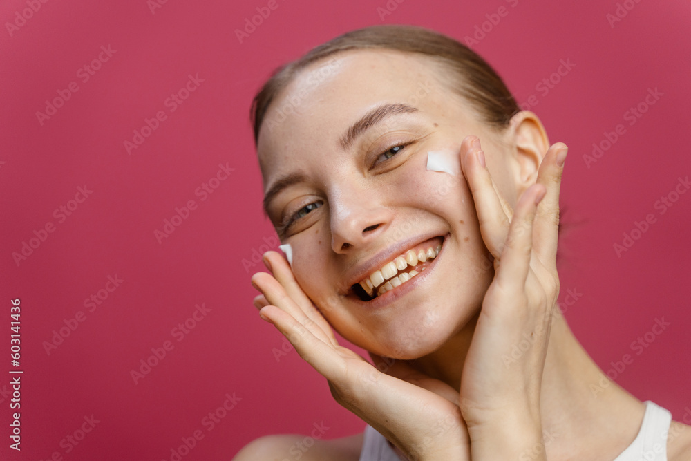 A woman puts cream on her face A woman puts cream on her face