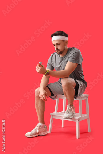 Young man in sportswear sit...
