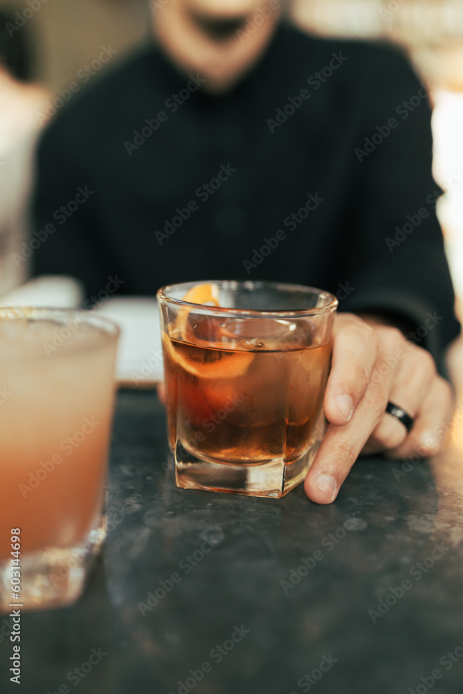 Man Holding Whiskey Cocktail at a Restaurant Man Holding Whiskey Cocktail at a Restaurant