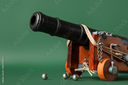 Toy model of cannon on green background, closeup