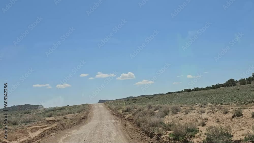 Hyperlapse - Forward view-Driving on a desert dirt road at hyper speed under blue sky Hyperlapse - Forward view-Driving on a desert dirt road at hyper speed under blue sky
