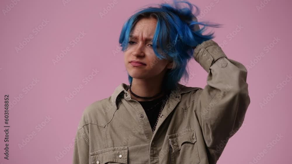 4k video of one girl touching with her hair and thinking about something over pink background. 4k video of one girl touching with her hair and thinking about something over pink background.
