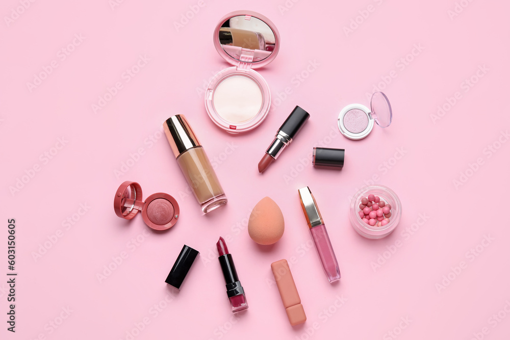 Decorative cosmetics with lipsticks and sponge on pink background Decorative cosmetics with lipsticks and sponge on pink background