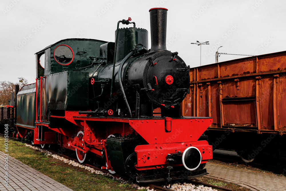 Fototapeta premium Vintage locomotive, steam train in an outdoor depot.