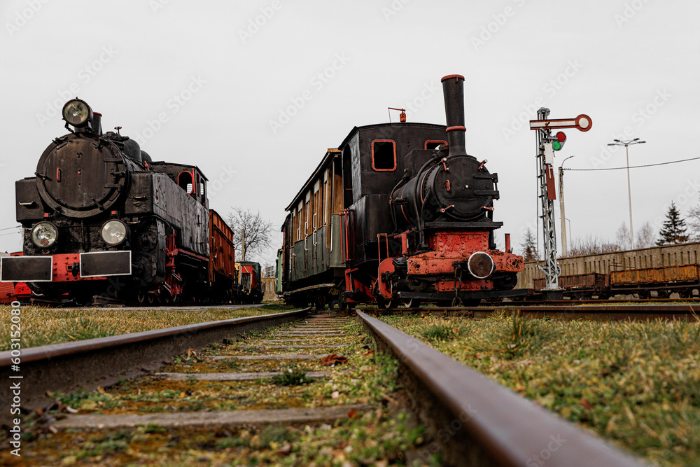 Vintage locomotive, steam train in an outdoor depot.