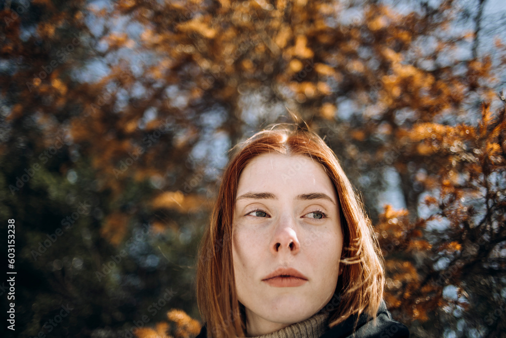 Portrait of a red-haired girl In autumn park Portrait of a red-haired girl In autumn park