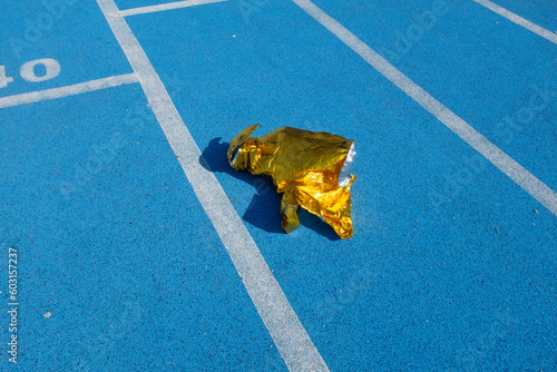 Golden metallic folio on a  blue sport running track photo