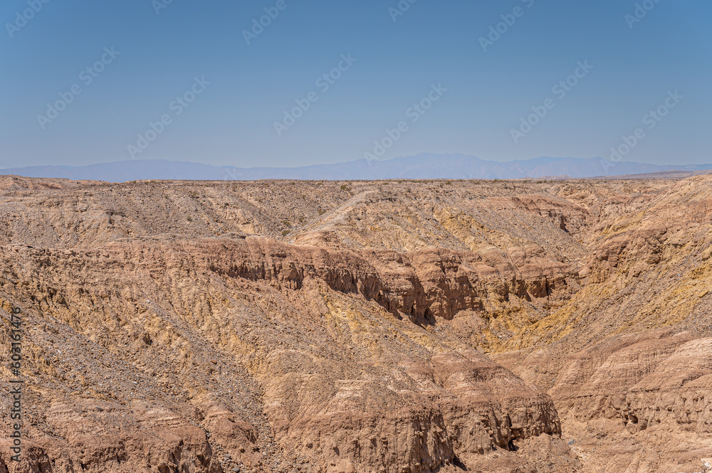Borrego Springs, CA, USA - April 24, 2023: Ocotillo Wells viewpoint along Borrego Salton Sea Way or S22 shows rough rocky landscape under blue sky Borrego Springs, CA, USA - April 24, 2023: Ocotillo Wells viewpoint along Borrego Salton Sea Way or S22 shows rough rocky landscape under blue sky