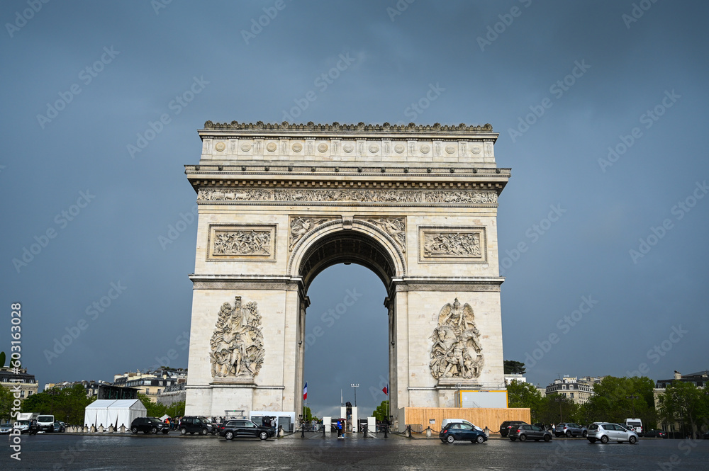 Paris, France: Arc de Triomphe in city centre. People visiting popular tourist attraction and historic landmarc in Paris. 