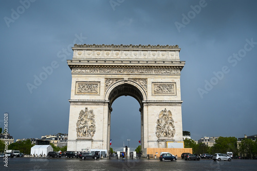 Paris, France: Arc de Triomphe in city centre. People visiting popular tourist attraction and historic landmarc in Paris.  photo