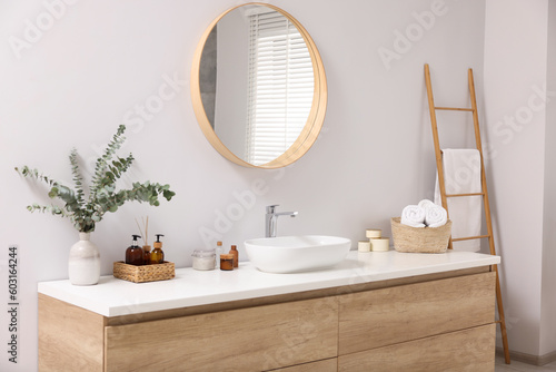 Beautiful stylish interior of bathroom with mirror and wash basin photo