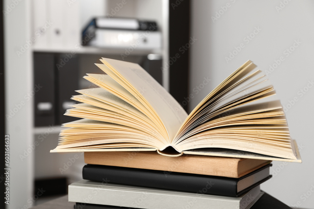 Fototapeta premium Stack of different hardcover books on wooden table indoors