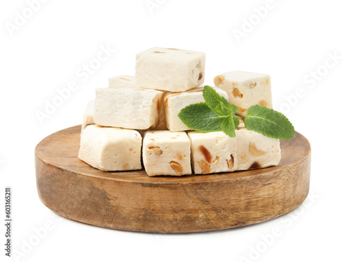 Pieces of delicious nougat and mint isolated on white photo