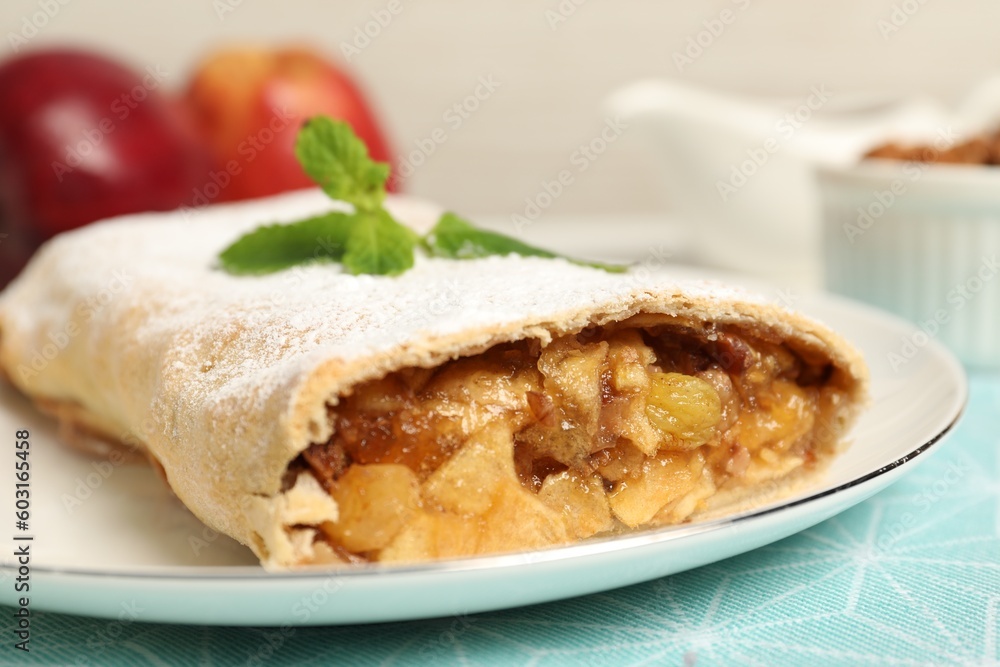 Delicious strudel with apples, nuts and raisins on table, closeup Delicious strudel with apples, nuts and raisins on table, closeup