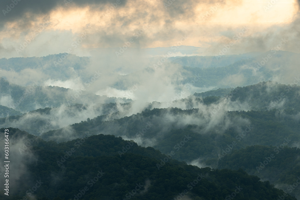 Evening Fog Lifting Over Mountains at Sunset Evening Fog Lifting Over Mountains at Sunset