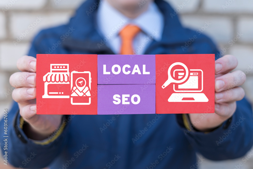 Man holding colorful blocks with icons and inscription: LOCAL SEO. Local search marketing e-commerce. Concept of local seo strategy, local search optimization. - obrazy, fototapety, plakaty 
