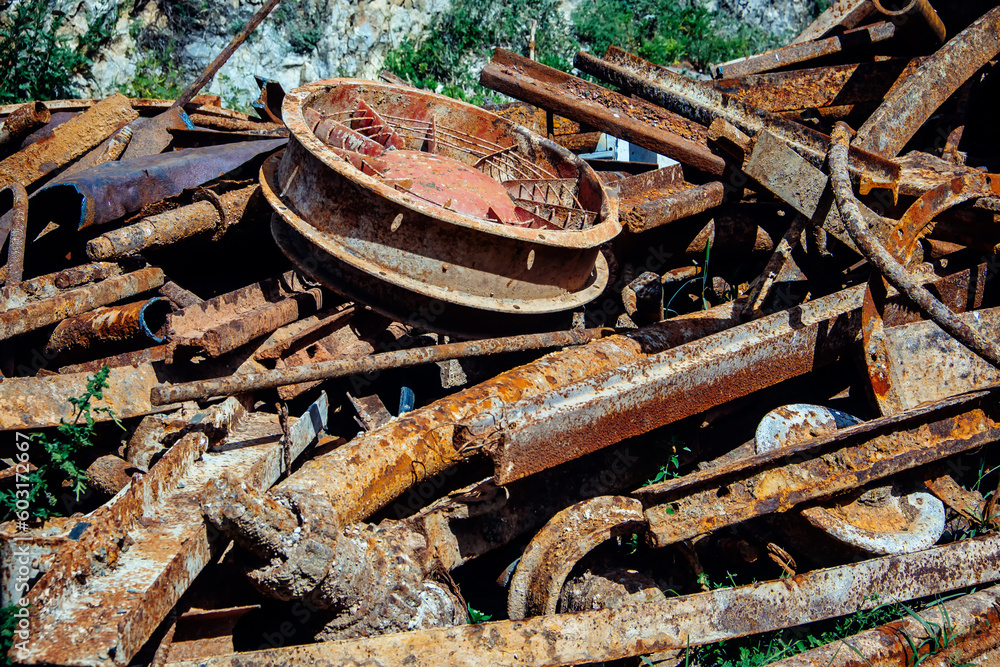 Close-up of a pile of rusty scrap metal. Metal waste for recycling.  Details of old machines and mechanisms.