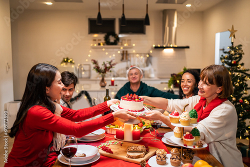 Multi-ethnic big family celebrating Christmas party together in house.