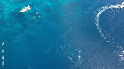 Stunning view overlooking two dinghys with divers on a beautiful blue water sea in Yangeffo Raja Ampat Indonesia photo