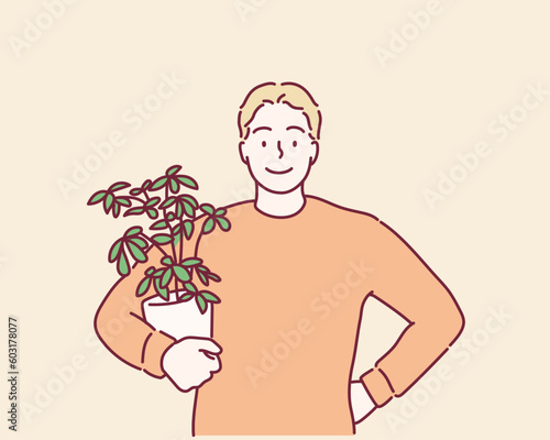 Happy young man holds a pot with decoration plant. Hand drawn style vector design illustrations.