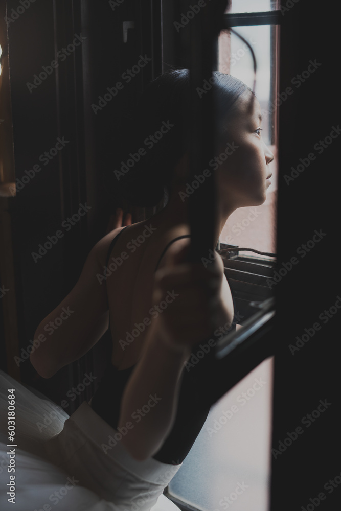 teenage ballet dancer looking out the window teenage ballet dancer looking out the window