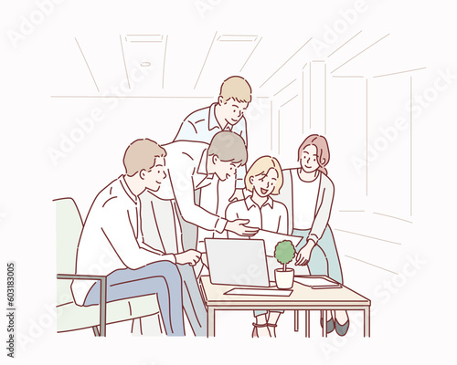 Group of young business people working and using laptop while sitting at the office desk together. Hand drawn style vector design illustrations.