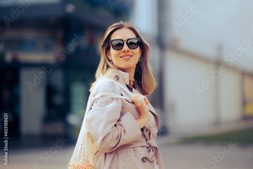 Shopping Woman with a Bag of Fruits in front of Supermarket Store. Shopper using sustainable plastic free bag for groceries 
