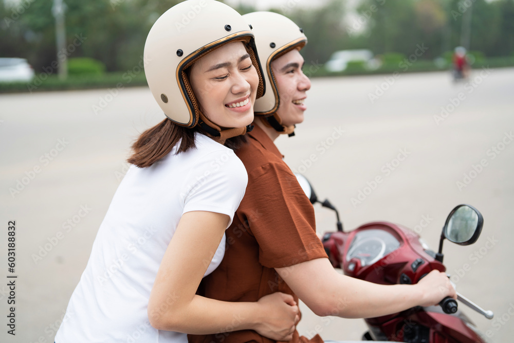 Young Asian couple on the motorbike