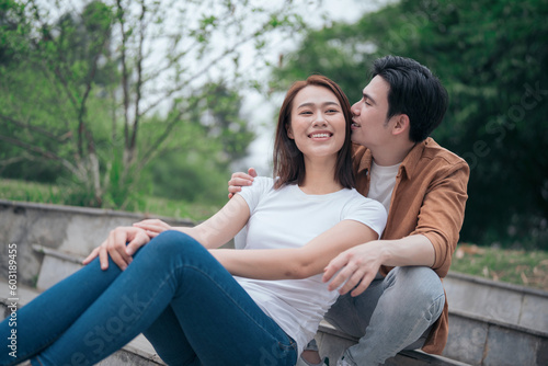 Photo of young Asian couple outside