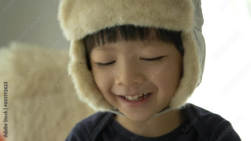 happy little boy wear hat playing and smiling in home, slow motion scene happy little boy wear hat playing and smiling in home, slow motion scene