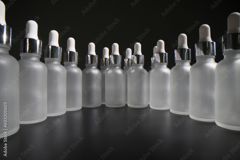 Large number of empty bottles with pipettes stand in circle Large number of empty bottles with pipettes stand in circle